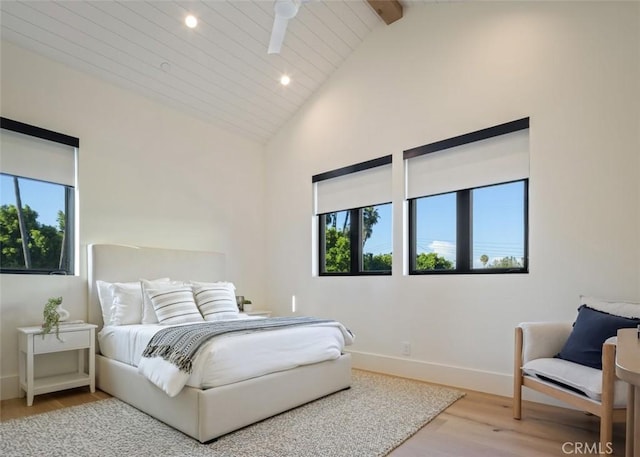 bedroom featuring baseboards, light wood-style flooring, beamed ceiling, high vaulted ceiling, and recessed lighting