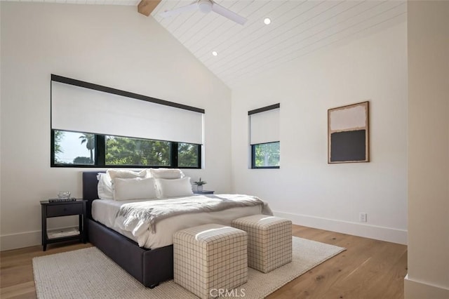 bedroom with baseboards, beamed ceiling, light wood-type flooring, high vaulted ceiling, and recessed lighting