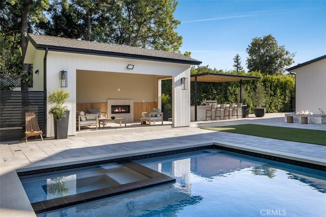 view of swimming pool featuring a patio, a pool with connected hot tub, an exterior structure, a bar, and an outdoor structure