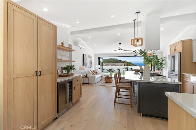 kitchen with light brown cabinets, beverage cooler, high end refrigerator, light countertops, and pendant lighting