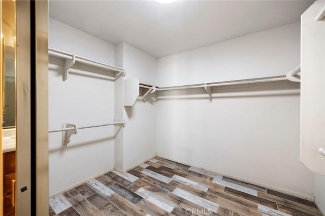 spacious closet with wood finished floors