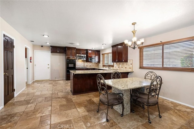 dining space featuring an inviting chandelier, baseboards, and stone tile flooring