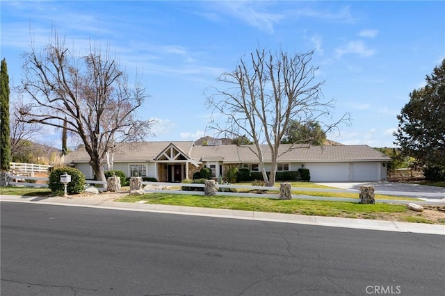 ranch-style home featuring driveway and an attached garage