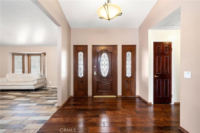 entryway featuring dark wood-style floors, baseboards, and a healthy amount of sunlight