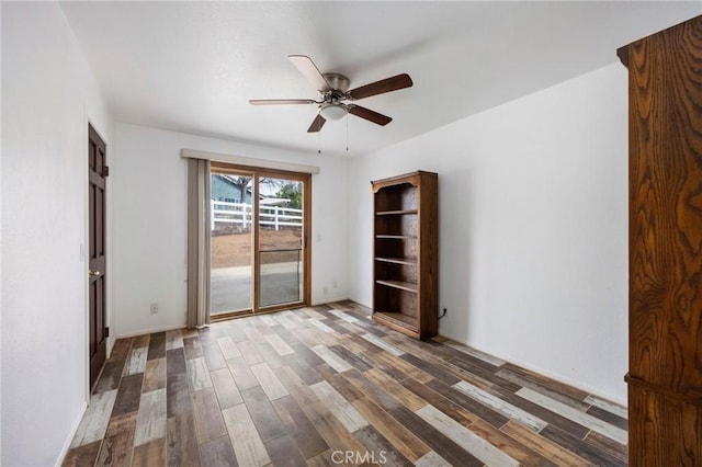 unfurnished room featuring dark wood-style flooring and ceiling fan