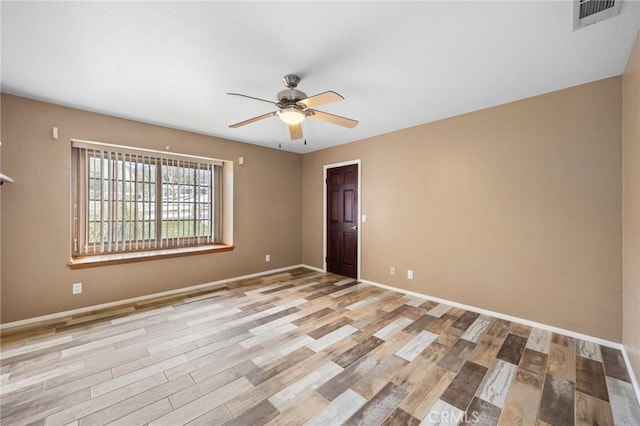 unfurnished room featuring baseboards, visible vents, ceiling fan, and light wood finished floors