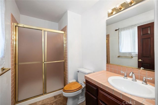 bathroom featuring vanity, backsplash, a shower stall, and toilet