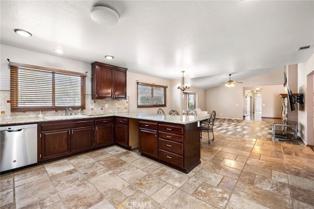 kitchen with visible vents, hanging light fixtures, a sink, dishwasher, and a peninsula