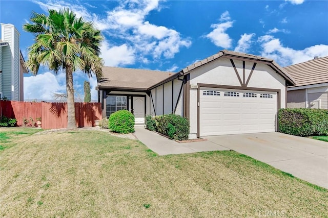 view of front facade with a garage, fence, concrete driveway, stucco siding, and a front lawn