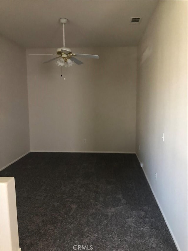 spare room with a ceiling fan, carpet flooring, visible vents, and baseboards