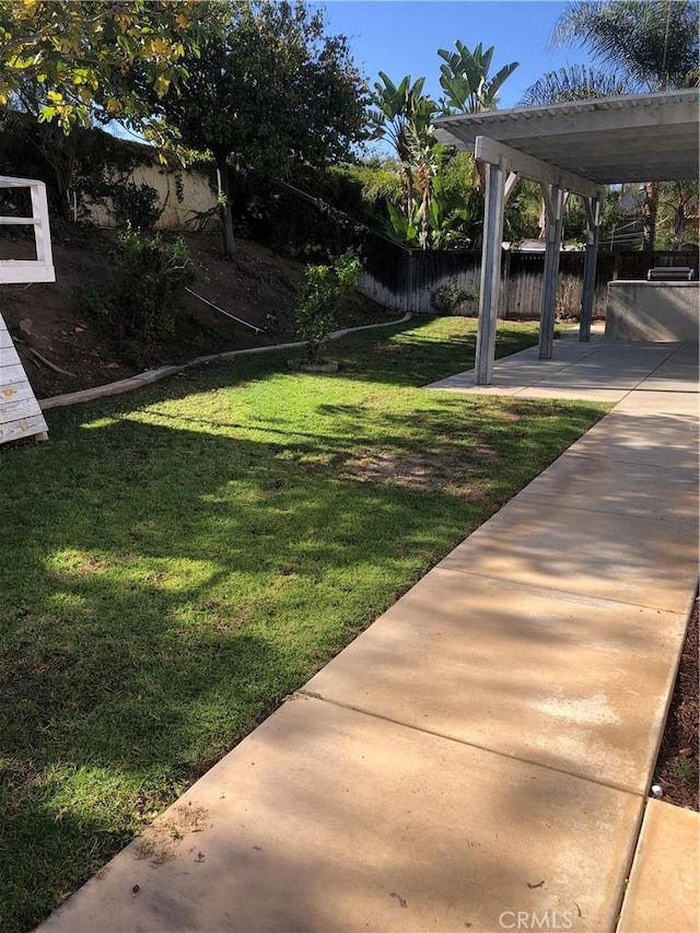 view of yard featuring a patio area and fence