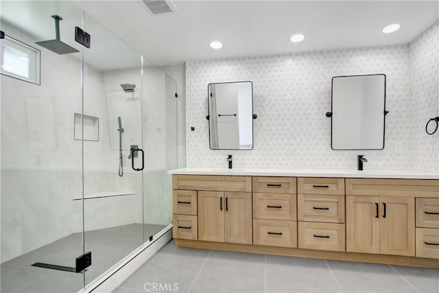 bathroom featuring double vanity, a stall shower, tile patterned flooring, and visible vents