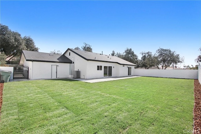 back of property featuring a yard, stucco siding, a gate, cooling unit, and a fenced backyard