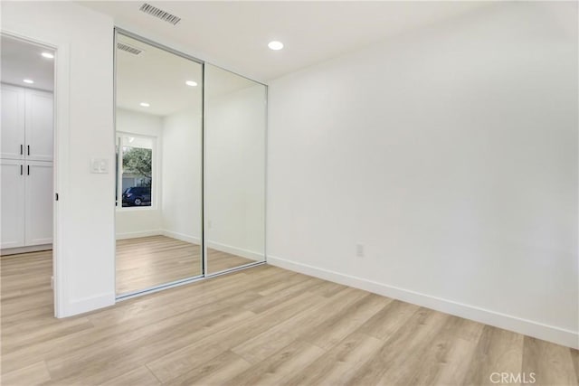 unfurnished bedroom featuring recessed lighting, visible vents, and light wood finished floors