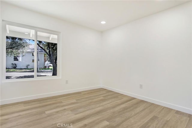 unfurnished room featuring recessed lighting, baseboards, and light wood finished floors