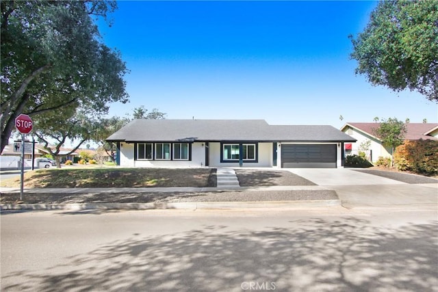 view of front of property featuring a garage and driveway