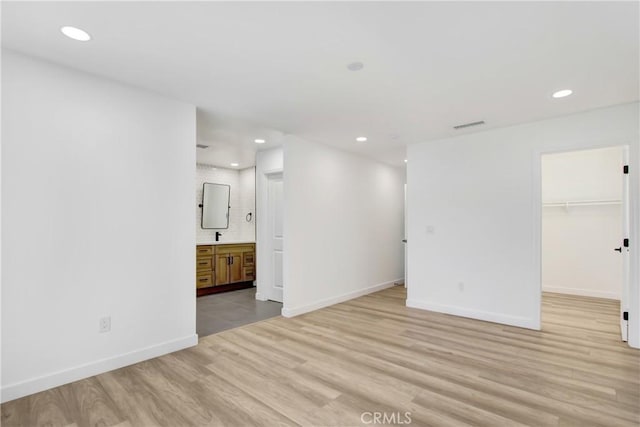 interior space with recessed lighting, light wood-style flooring, and baseboards