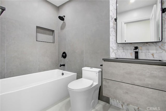 full bathroom with toilet, shower / bathing tub combination, a sink, and tile walls