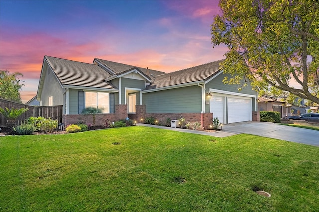 view of front of property with a garage, brick siding, fence, concrete driveway, and a front lawn