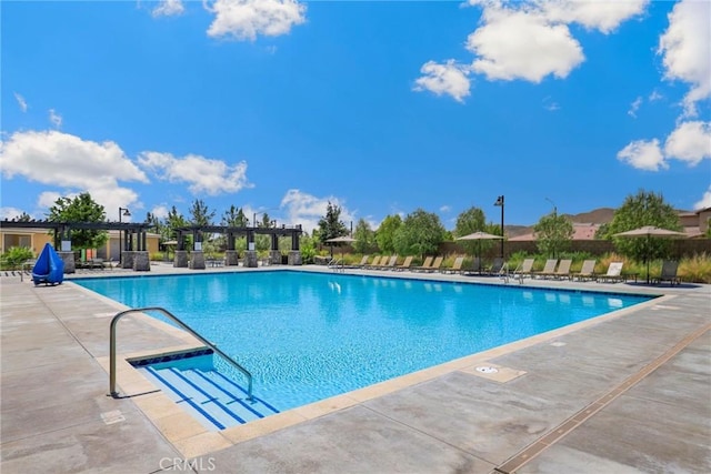 pool featuring a pergola and a patio