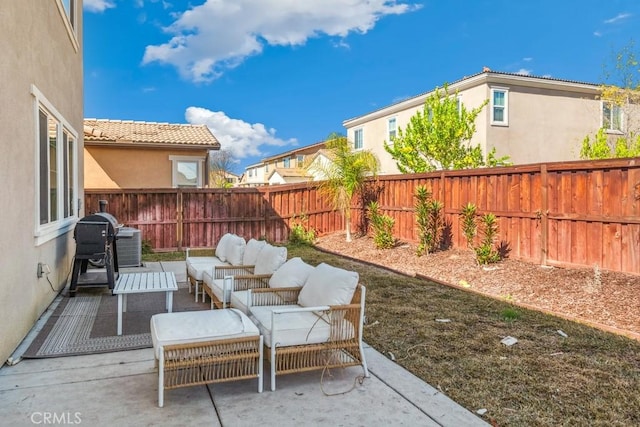 view of patio featuring a fenced backyard, a grill, and outdoor lounge area