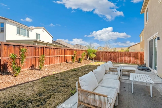 view of yard with a patio area, a fenced backyard, and outdoor lounge area