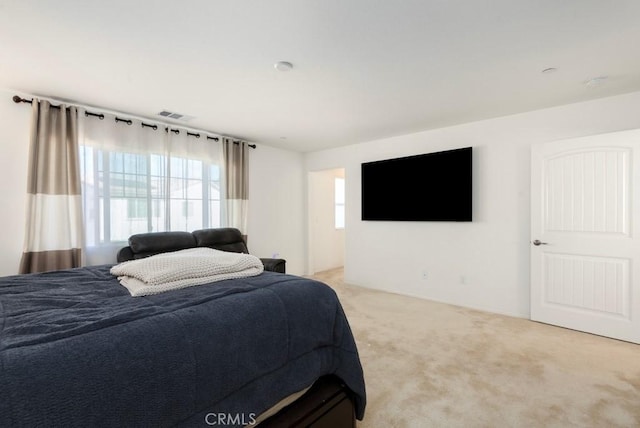 bedroom featuring light colored carpet and visible vents