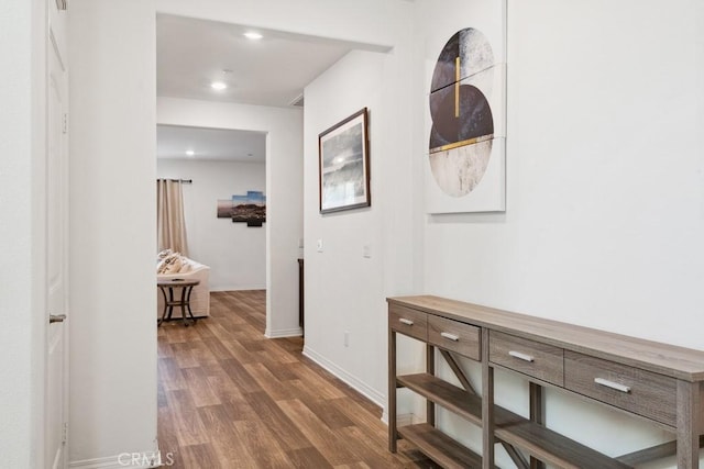 hall with baseboards, wood finished floors, and recessed lighting