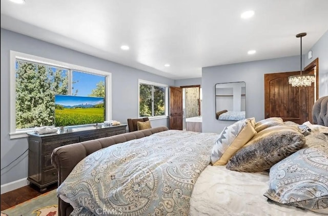 bedroom with recessed lighting, dark wood finished floors, baseboards, and an inviting chandelier