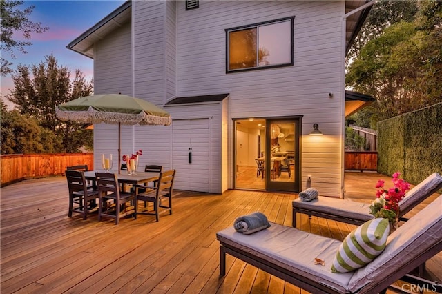 deck featuring fence and outdoor dining space