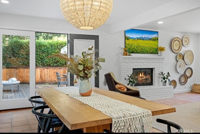 dining area with a brick fireplace, tile patterned floors, baseboards, and recessed lighting