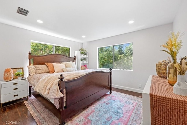 bedroom with recessed lighting, dark wood-style flooring, visible vents, and multiple windows