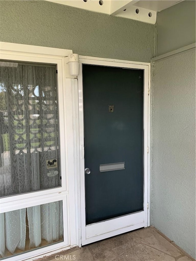 view of exterior entry with stucco siding