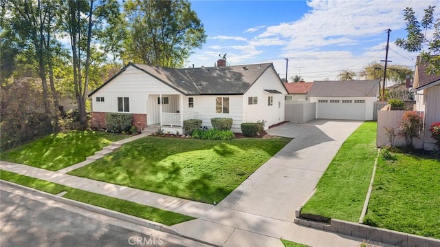 view of front of house featuring a detached garage, a chimney, a front lawn, and fence