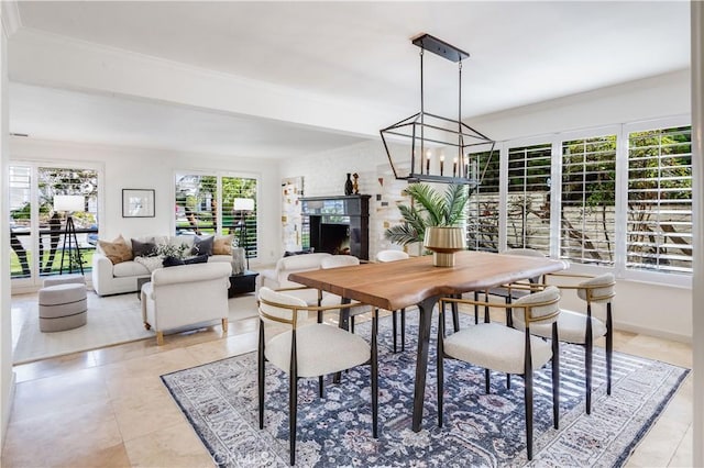 dining area with light tile patterned floors, a fireplace, baseboards, and an inviting chandelier