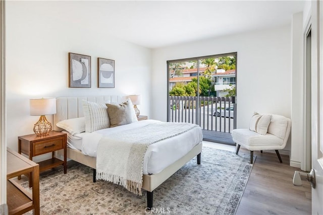 bedroom with light wood-style flooring and access to exterior