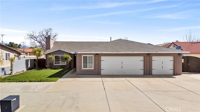 ranch-style house featuring stucco siding, concrete driveway, fence, a garage, and a front lawn