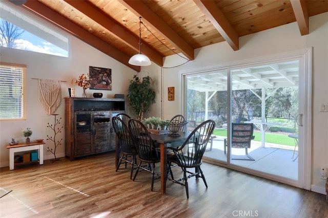 dining space with a wealth of natural light and wood finished floors