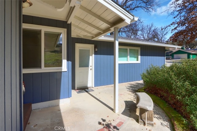 doorway to property with a patio area and board and batten siding