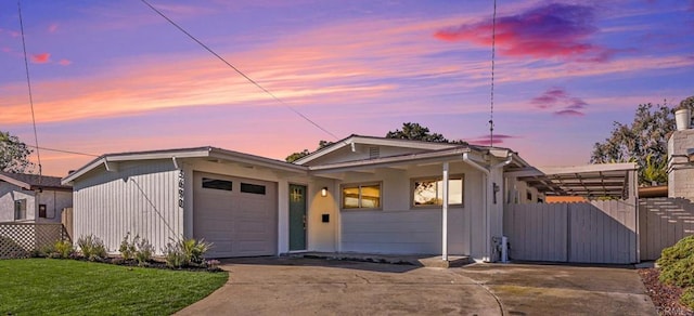 view of front of property with driveway, a lawn, and an attached garage