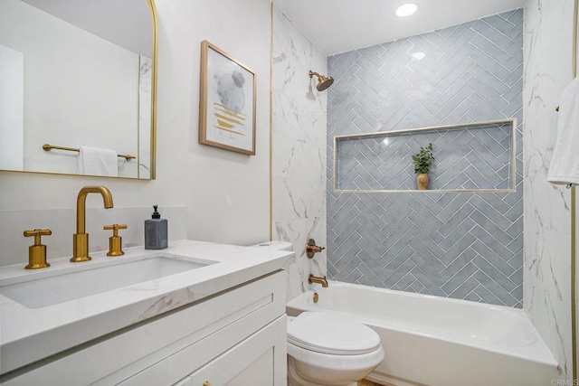 bathroom featuring toilet, shower / bathing tub combination, and vanity