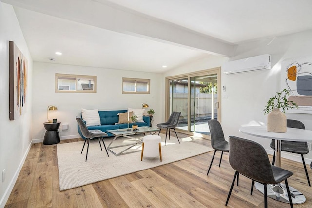 living area with light wood-style flooring, recessed lighting, baseboards, a wall mounted AC, and beam ceiling