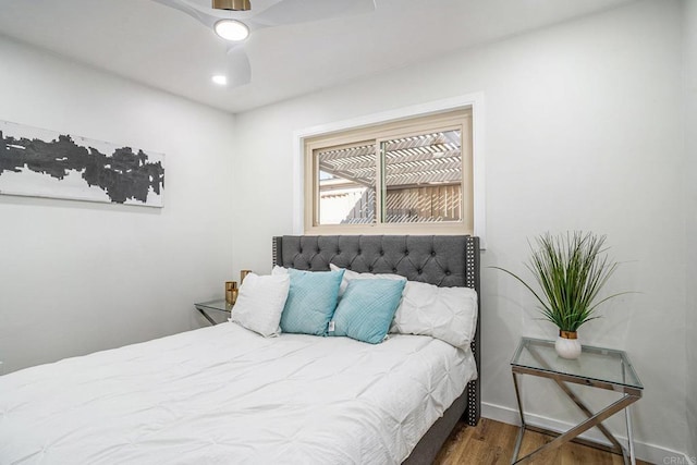 bedroom featuring dark wood-style flooring, ceiling fan, and baseboards