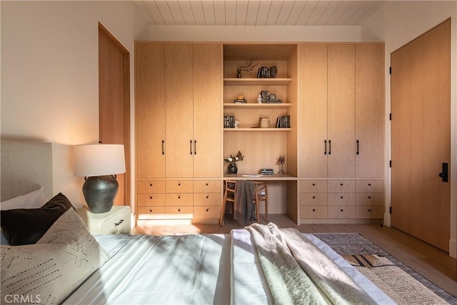 bedroom with light wood-type flooring and wood ceiling