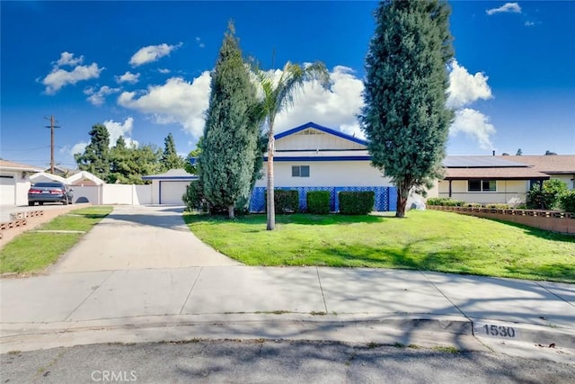 single story home with a front lawn and fence