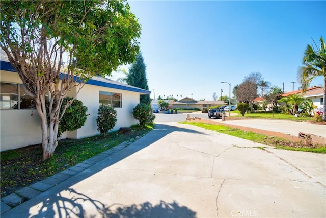 view of street with concrete driveway and a residential view