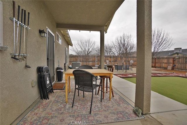 view of patio with outdoor dining space, a fenced backyard, and central air condition unit