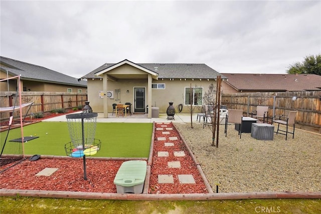 back of house featuring a patio area, a fenced backyard, and stucco siding