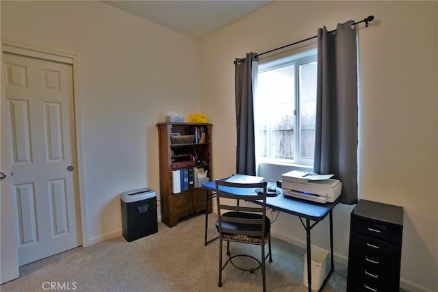 office area featuring baseboards and light colored carpet