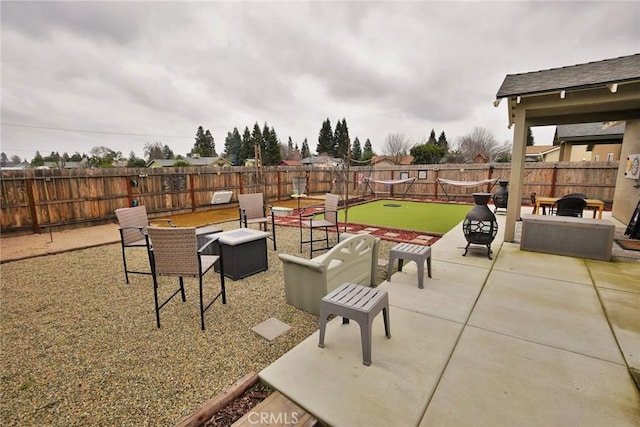 view of patio / terrace featuring an outdoor fire pit and a fenced backyard